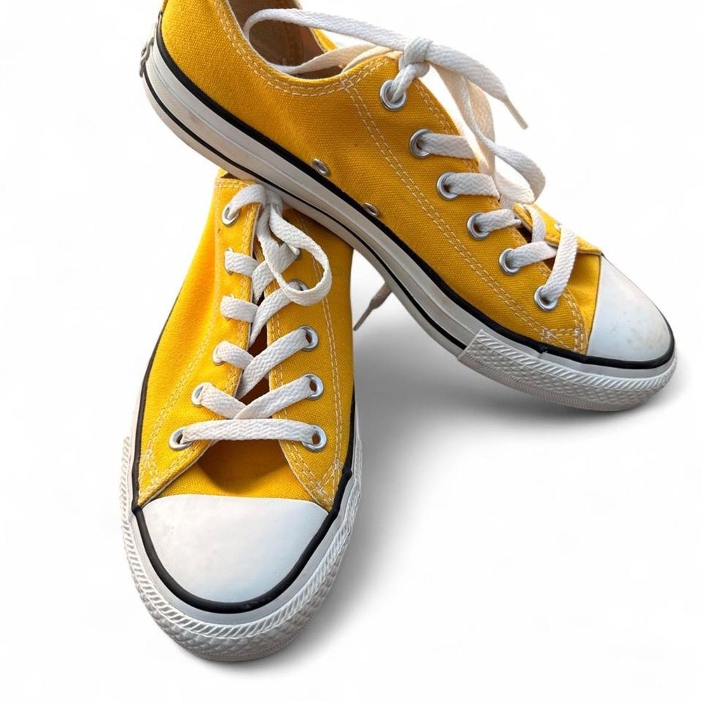 Yellow Converse sneakers with white laces and white rubber toe cap